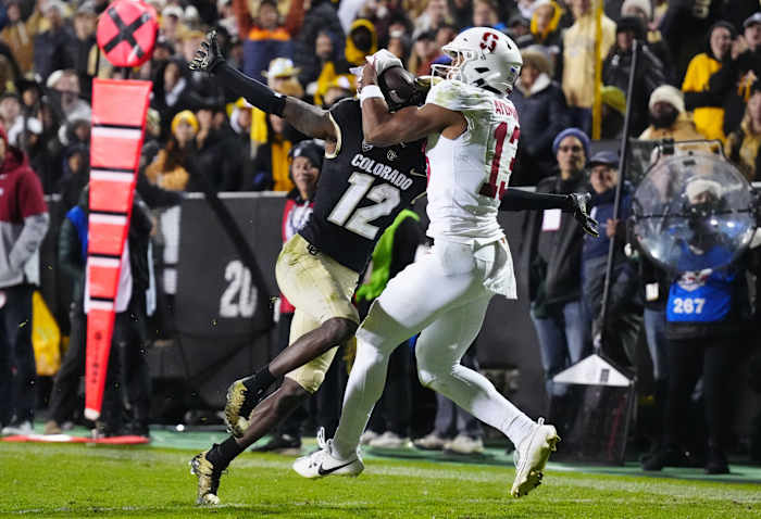 Oct 13, 2023; Boulder, Colorado, USA; Stanford Cardinal wide receiver Elic Ayomanor (13) pulls in a touchdown behind the pack of Colorado Buffaloes cornerback Travis Hunter (12) in overtime at Folsom Field. Mandatory Credit: Ron Chenoy-USA TODAY Sports